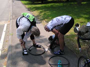 George and Jane fixing a flat tire for the third time